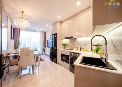 Modern kitchen and dining area with white cabinetry and elegant decor in SIAMIQ apartment.