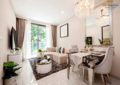 Modern living room with large window, elegant furniture, and stylish decor in SIAMIQ apartment.