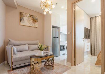 Elegant modern living room with sofa, coffee table, and stylish decor in SIAMIQ apartment.