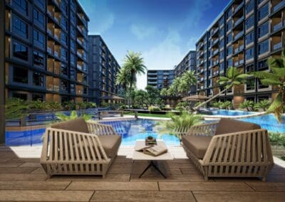 Luxusný bazén s ležadlami a palmami v modernom apartmánovom komplexe SIAMIQ na Thajsku.