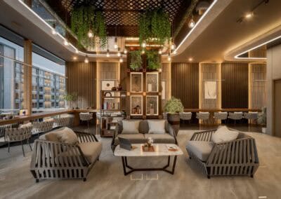 Modern hotel lobby with stylish furniture and hanging greenery decor.