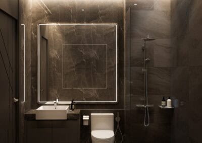 Modern bathroom with dark marble walls, illuminated mirror, and walk-in shower.