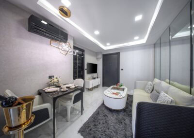 Modern, elegant living room with white sofa, dining area, and glass wall in SIAMIQ.