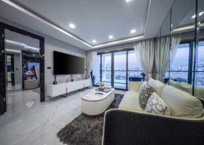 Modern living room with large windows and city view in Siamiq apartment.